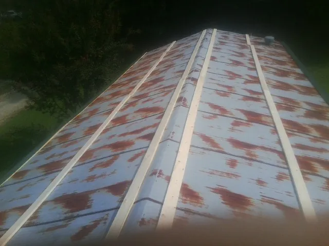 Rusted metal roof panels with new wood purlins before replacement — Storm Damage Roof Repair in Philadelphia by Roofing Brothers